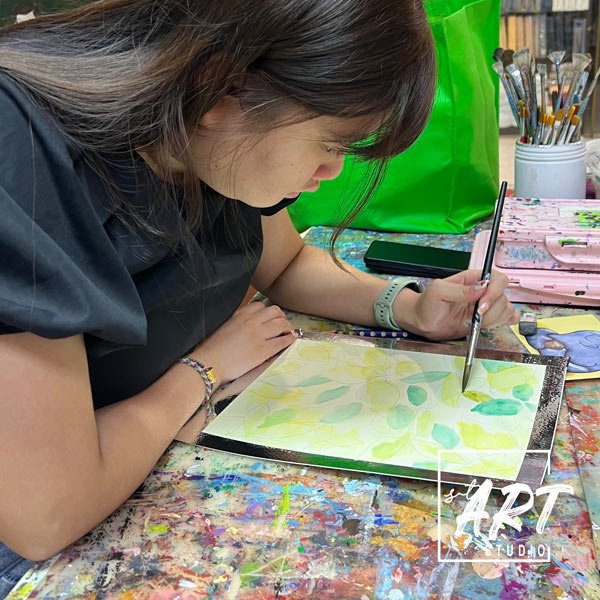 Creative art class for kids Singapore, student learning painting techniques