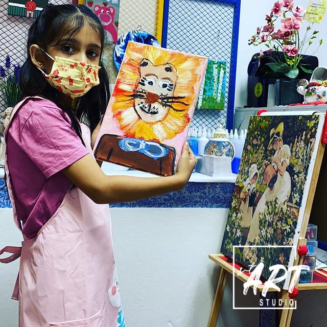 Girl with colourful lion painting